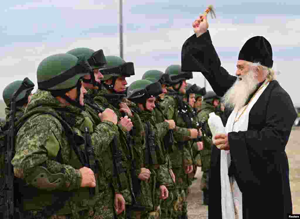 A priest sprinkles holy water on Russian reservists in the Rostov region who were recruited during the Kremlin&#39;s partial mobilization of troops before their departure to the Ukraine war zone.