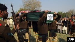 Pakistani soldiers carry the coffin of and officer killed by militants.