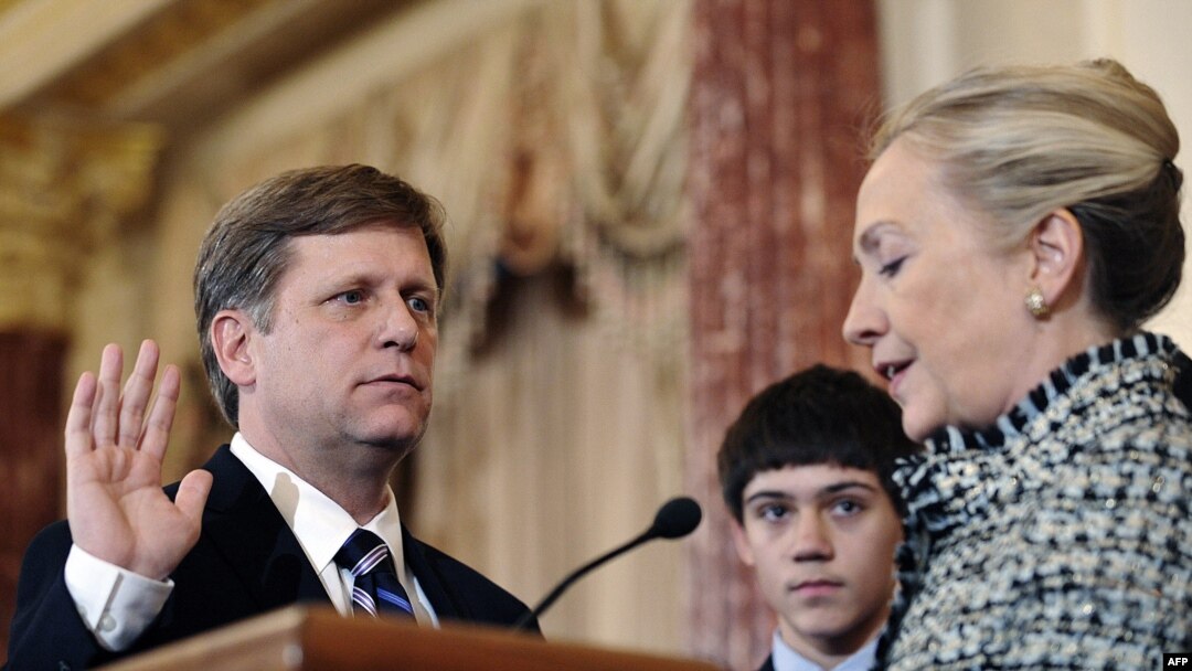 U.S. Secretary of State Hillary Clinton (right) gives the oath of office to ambassador-designate to Russia Mike McFaul in Washington on January 10.