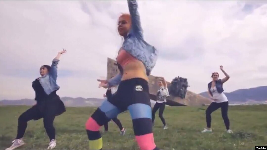 A screen grab from the music video on YouTube of six women dancing provocatively against the backdrop of a World War II memorial in Novorossiisk, Russia.
