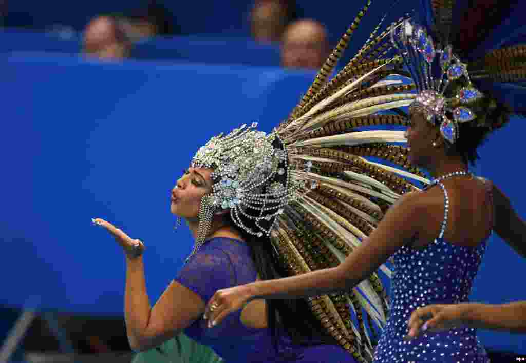 Samba dancers pose at the Olympic Aquatics Stadium in Rio.