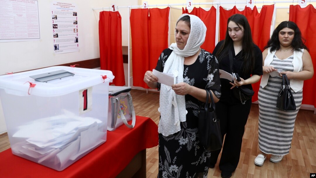 Voters line up to cast their ballots at a polling station in Baku on September 1. 
