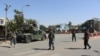 Afghan policeman stand alert during fighting between Taliban militants and Afghan security forces in Kunduz city on October 3.