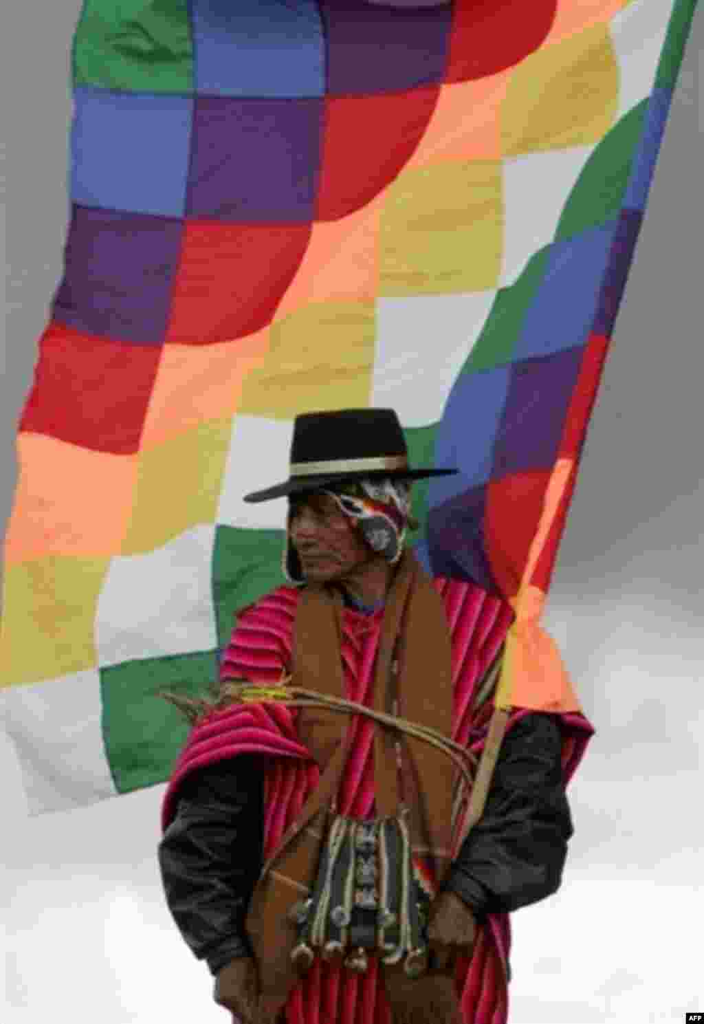 A native Bolivian holds a flag symbolizing the old Inca empire at an Indian ceremony to induct Evo Morales as Bolivia's president in January (AFP) - A tidal wave of elections -- 12 in 13 months -- moved Latin American politics leftward and placed a series of colorful, unusual, controversial, and sometimes familiar faces in presidential palaces. While some -- chiefly Venezuela's Hugo Chavez -- struck an anti-U.S. note, increased social spending and deeper regional integration were more important issues for most.