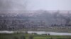 Smoke rises from a besieged village in Syria's Deir al-Zor Province in 2019. Iranian militias have a strong presence in the area and have long targeted the nearby al-Omar oil field, where the U.S. coalition has a major base.
