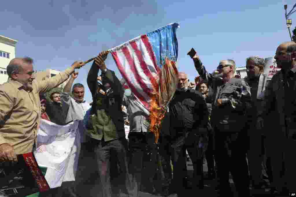 Iranian worshippers burn a U.S. flag during an anti-Israeli rally after Friday Prayers in Tehran.&nbsp;