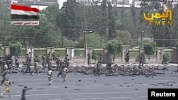 Army personnel run to the scene of the suicide attack in Yemen's capital Sanaa on May 21. 