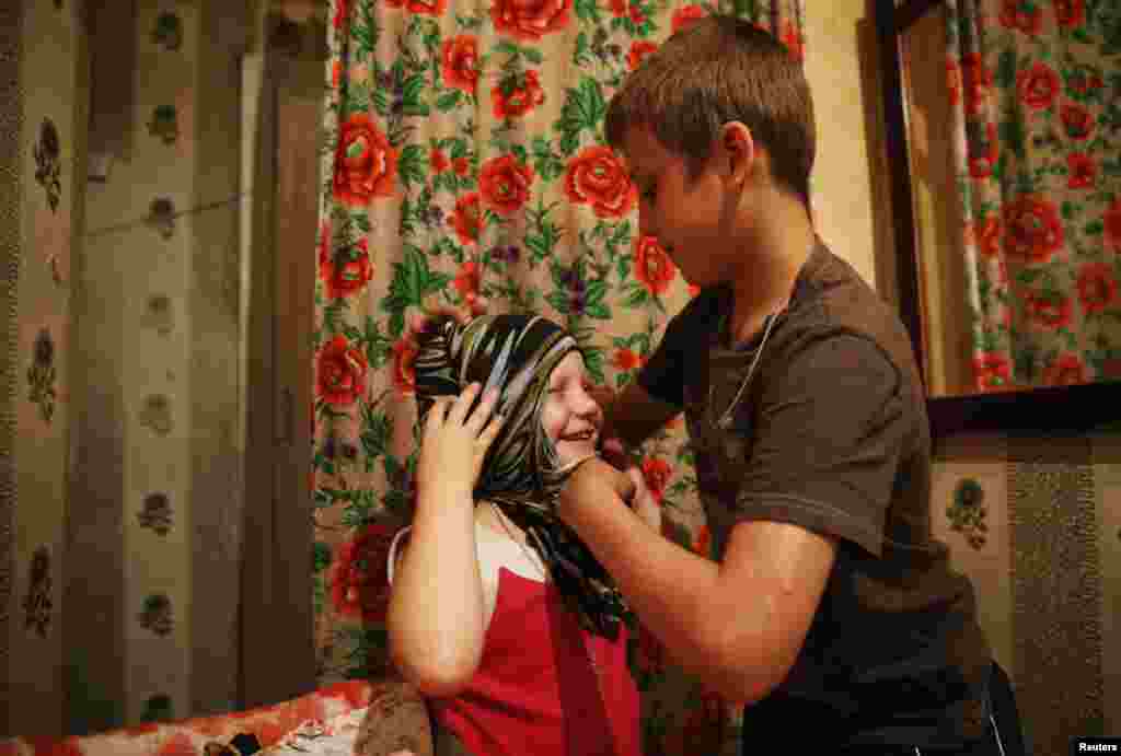 Children of families who have fled from fighting in Slovyansk play together at a temporary accommodation in the town of Nyzhnya Krynka in eastern Ukraine on June 3.