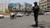 A security guard patrols a street in Tehran in the early hours of a cease-fire between Israel and Iran on June 24. Iranian police reported detaining around 21,000 people for alleged security violations during the 12-day war, though the number still in custody is unclear.