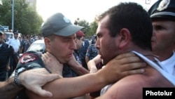 Armenia - A youth activist clashes with a policeman during a demonstration against an electricity price rise, Yerevan, 1Aug2015.