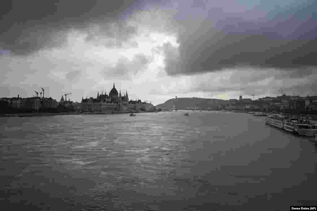 Dark clouds are seen over the Parliament building as the city braces for the coming deluge.