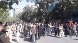 People march in protest near the Central Kabul Bank, in Kabul, Afghanistan, August 28, 2021, in this still image obtained by Reuters from a social media video. 