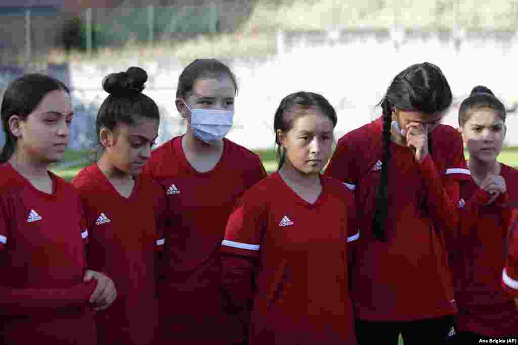 Some of the younger members of the Afghanistan national girls soccer teams listen to Farkhunda Muhtaj, the captain of the Afghanistan women&#39;s senior team during a training session at a soccer pitch in Odivelas, outside Lisbon, Thursday, Sept. 30, 2021