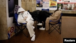 People take shelter in a subway station during a Russian missile strike in Kyiv on March 24.