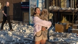 A resident stands outside a damaged apartment building following a Russian attack on the Ukrainian city of Odesa, on the Black Sea coast, early on September 12.