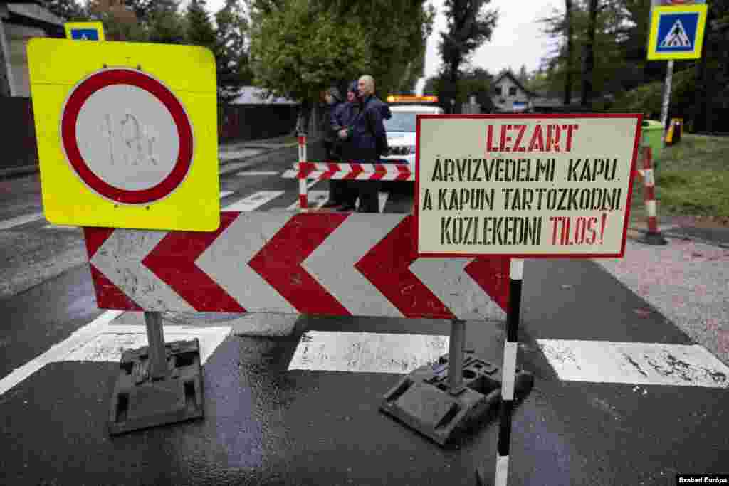 Signs warn residents that access to the Roman Shore neighborhood is restricted due to rising floodwaters. &nbsp;