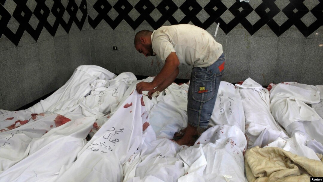 A man searches for bodies of his relatives who were supporters of ousted Egyptian President Muhammad Morsi after scores were killed in Cairo.