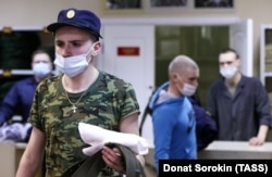 Army conscripts receive their uniforms at the Yegorshino regional assembly station before departing for service with the Russian military in April 2021.