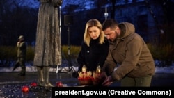 Ukrainian President Volodymyr Zelenskiy and his wife, Olena Zelenska, attend a memorial to the victims of the Holodomor famine of 1932-1933, in Kyiv on November 26.