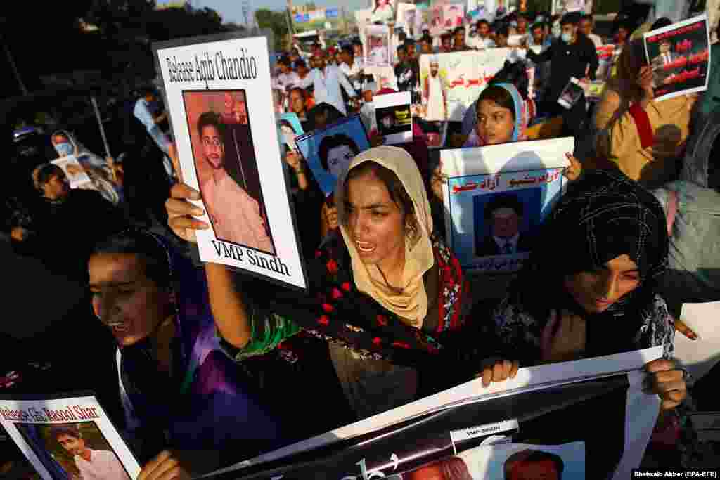 Demonstrators hold up pictures of missing relatives, whom Pakistani human rights activists claim have been picked up by state agencies, primarily under the pretext of fighting terrorism, during a protest in Karachi on October 4. (epa-EFE/Shahzaib Akber)