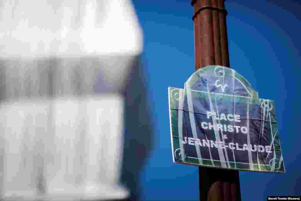 A mock street sign near the Arc de Triomphe renames the central Paris landmark after Christo and Jeanne-Claude. The couple were born in Bulgaria and Morocco, respectively, on the same day in 1935. The late artists were famous for creating some of the most spectacular and logistically challenging artworks ever made, including the Wrapped Reichstag in Berlin and The Floating Piers.