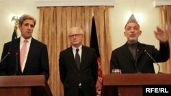 Afghan President Hamid Karzai (right) and U.S. Senator John Kerry in Kabul, with the UN's Kai Eide -- Kerry praised Karzai's "dedication to building a lasting democracy."