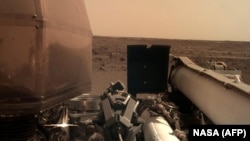 26 ноября 2018 аппарат NASA InSight передал с поверхности Марса этот снимок. Видны части зонда и поверхность планеты