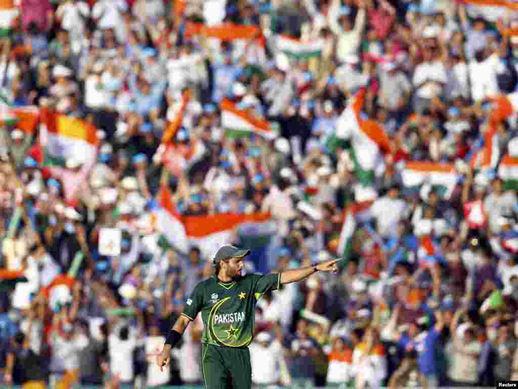 Pakistan's captain Shahid Afridi adjusts the fielding positions of his team during their ICC Cricket World Cup 2011 semifinal match against India in Mohali on March 30. Photo by Adnan Abidi for Reuters