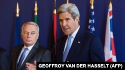 U.S. Secretary of State John Kerry speaks as French Foreign Minister Jean-Marc Ayrault looks on following talks in Paris.