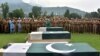 FILE: Pakistani army officials and soldiers pray beside coffins holding the bodies of three colleagues killed in cross border shelling during a funeral in Muzaffarabad, capital of the Pakistan-administered Kashmir in August.