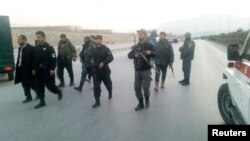 Afghan policemen keep watch at the site of a suicide bomb attack near the parliament building in Kabul on January 10.