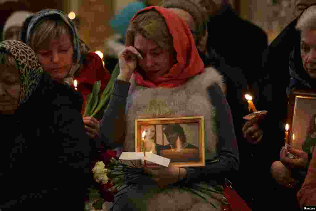 Relatives of victims of the April 3 subway bombing in St. Petersburg attend a memorial service at Trinity Cathedral in the city. (Reuters/Anton Vaganov)