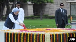 Indian Prime Minister Manmohan Singh places a floral tribute at the Samadhi of Mahatma Gandhi at Rajghat during celebrations of the country's 67th Independence Day in New Delhi on August 15.