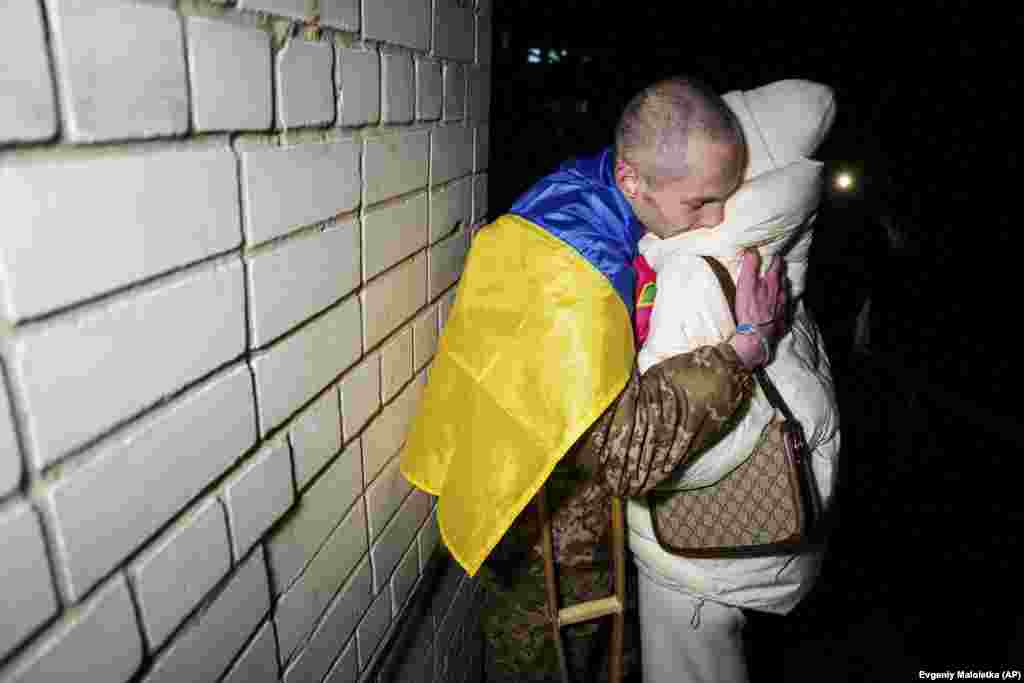 A Ukrainian soldier hugs his wife after returning from captivity during a prisoner exchange between Russia and Ukraine.&nbsp;