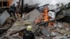 Firefighters work at the site of an apartment building hit by a Russian air strike, amid Russia's attack on Ukraine, in Kharkiv, Ukraine, on January 2.