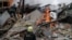 Firefighters work at the site of an apartment building hit by a Russian air strike, amid Russia's attack on Ukraine, in Kharkiv, Ukraine, on January 2.
