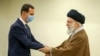 (FILES) This file handout picture provided by the office of Iran's Supreme Leader Ayatollah Ali Khamenei on May 08, 2022 shows him (R) greeting Syrian President Bashar al-Assad (L) in Tehran.