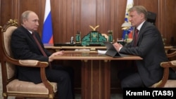 Russian President Vladimir Putin (left) speaks with Sberbank CEO German Gref during a meeting in Moscow in September 2019.