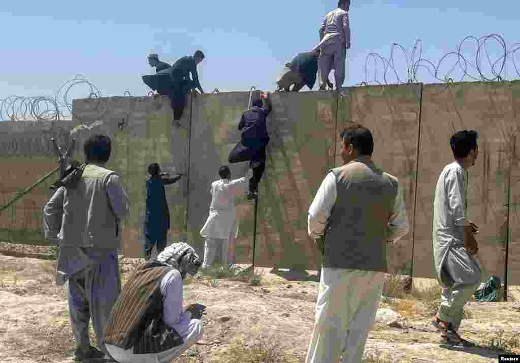 People climbing the airport wall.