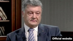 Ukrainian President Petro Poroshenko speaks to the 1+1 TV channel in Kyiv on May 12.