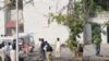 Police and rescue workers attend to victims of the suicide bombings near Islamabad.