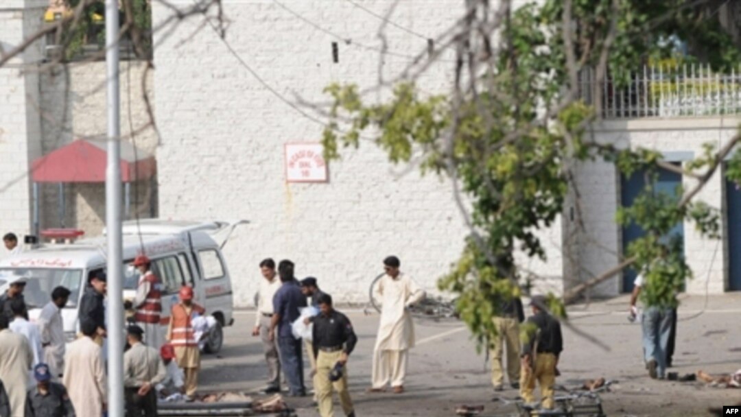 Police and rescue workers attend to victims of the suicide bombings near Islamabad.