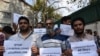 FILE: Kashmiri journalists hold placards during a protest against the communication blackout at Press Club Kashmir in Srinagar, the summer capital of Indian administered Kashmir in October 2019.