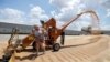 RUSSIA - An employee loads wheat near a grain store in the settlement of Raduga in Stavropol Region, Russia June 30, 2021