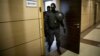 Russian police are shown raiding the offices of Aleksei Navalny's Anti-Corruption Foundation in Moscow on July 17.