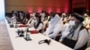 Delegates attend talks that kicked off between the Afghan government and Taliban insurgents in Doha on September 12.