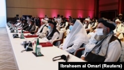 Delegates attend talks that kicked off between the Afghan government and Taliban insurgents in Doha on September 12.