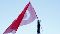 A Turkish flag is put in the barrel of an armored vehicle parked outside the parliament building in Ankara on July 16.