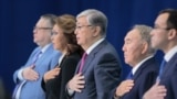 KAZAKHSTAN -- Former Kazakh president Nursultan Nazarbaev, Kazakh interim President Qasym-Zhomart Toqaev and other attendees listen to the national anthem as they attend a congress of the ruling Nur Otan party in Nur-Sultan, April 23, 201