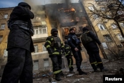 Firefighters work to put out a fire at a residential building hit by a Russian missile strike in Bakhmut on December 7.